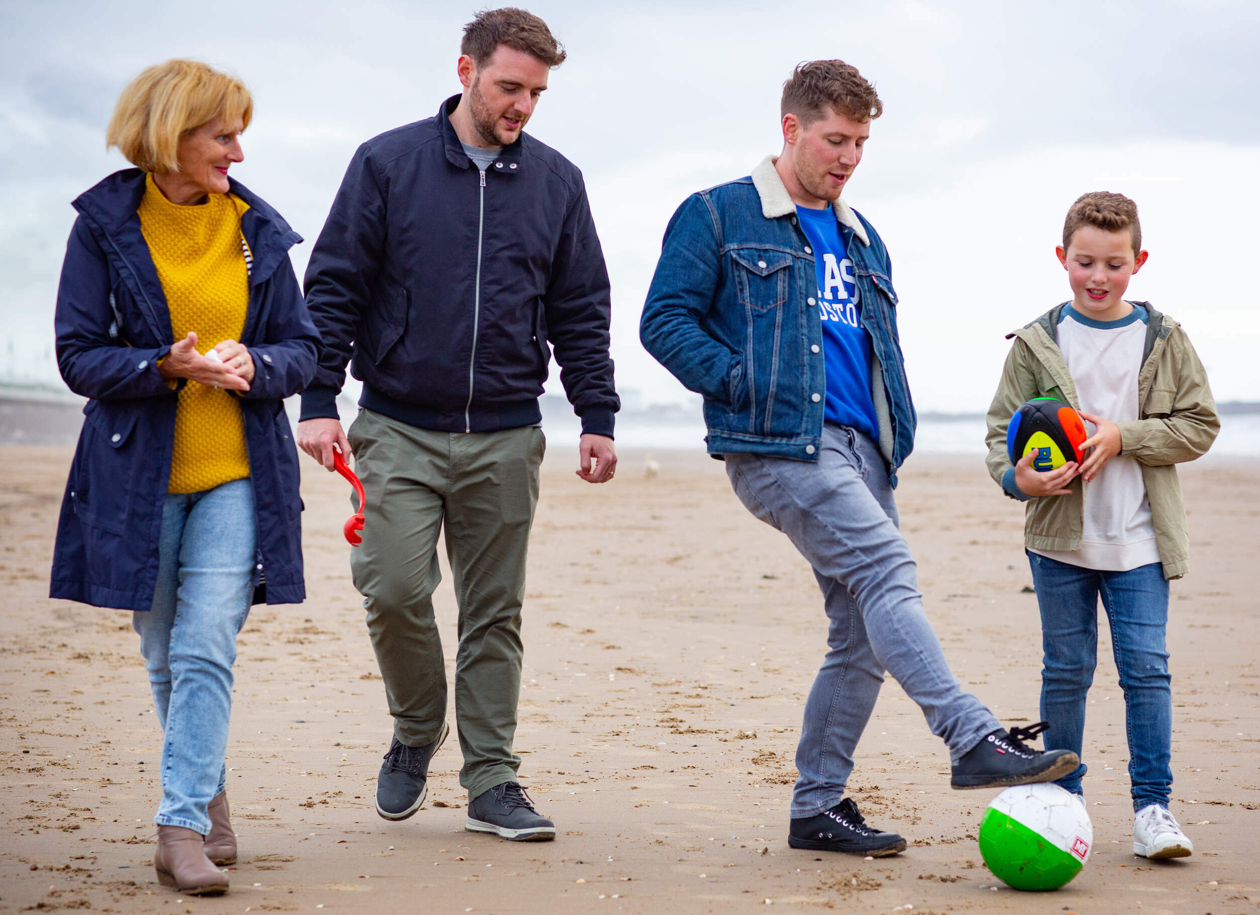 Two men and a woman with a child Foster Wales
