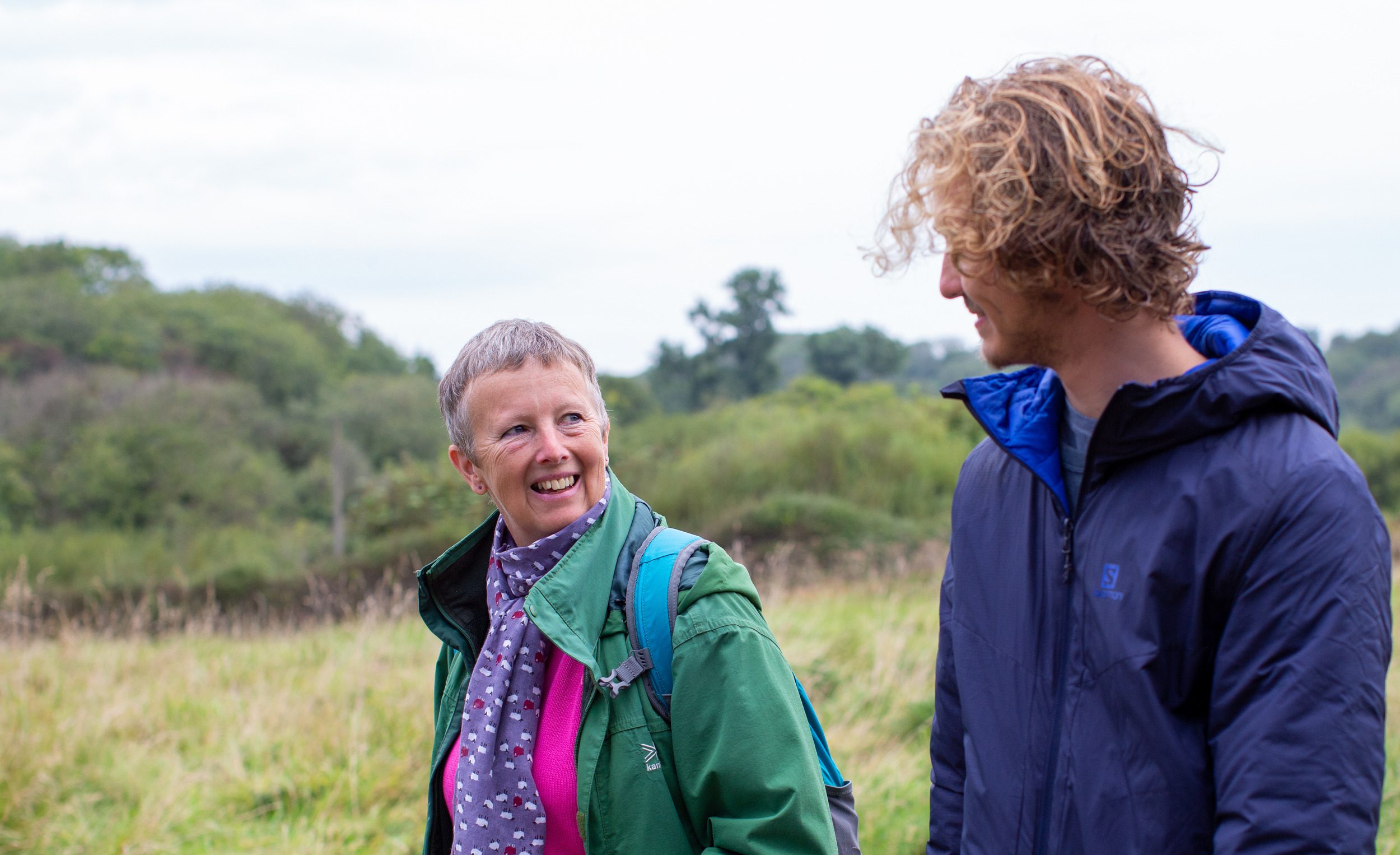 A young man walking with a woman